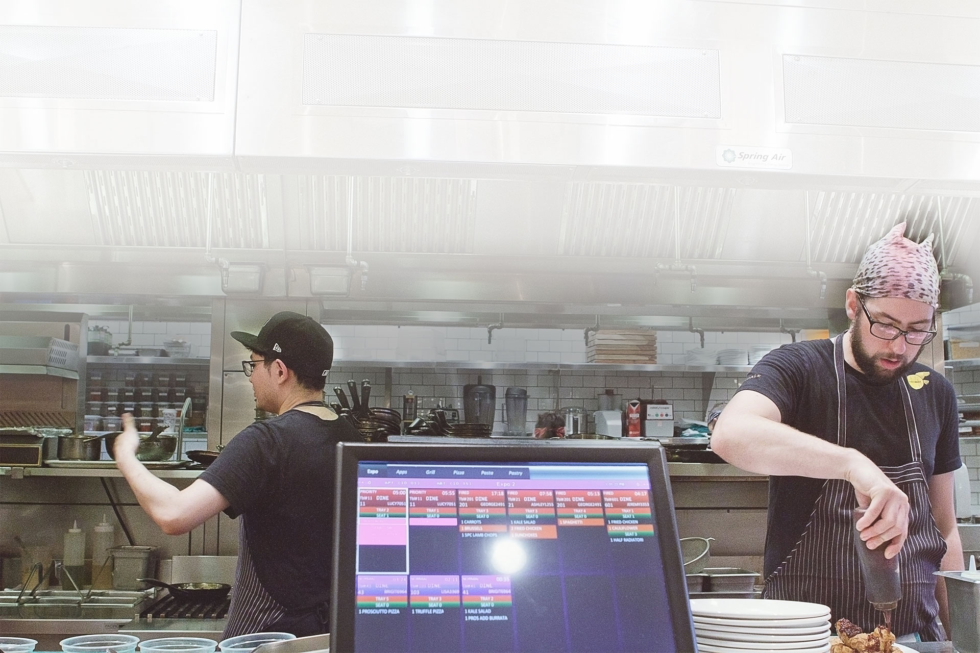 chefs in a kitchen with a Squirrel POS terminal