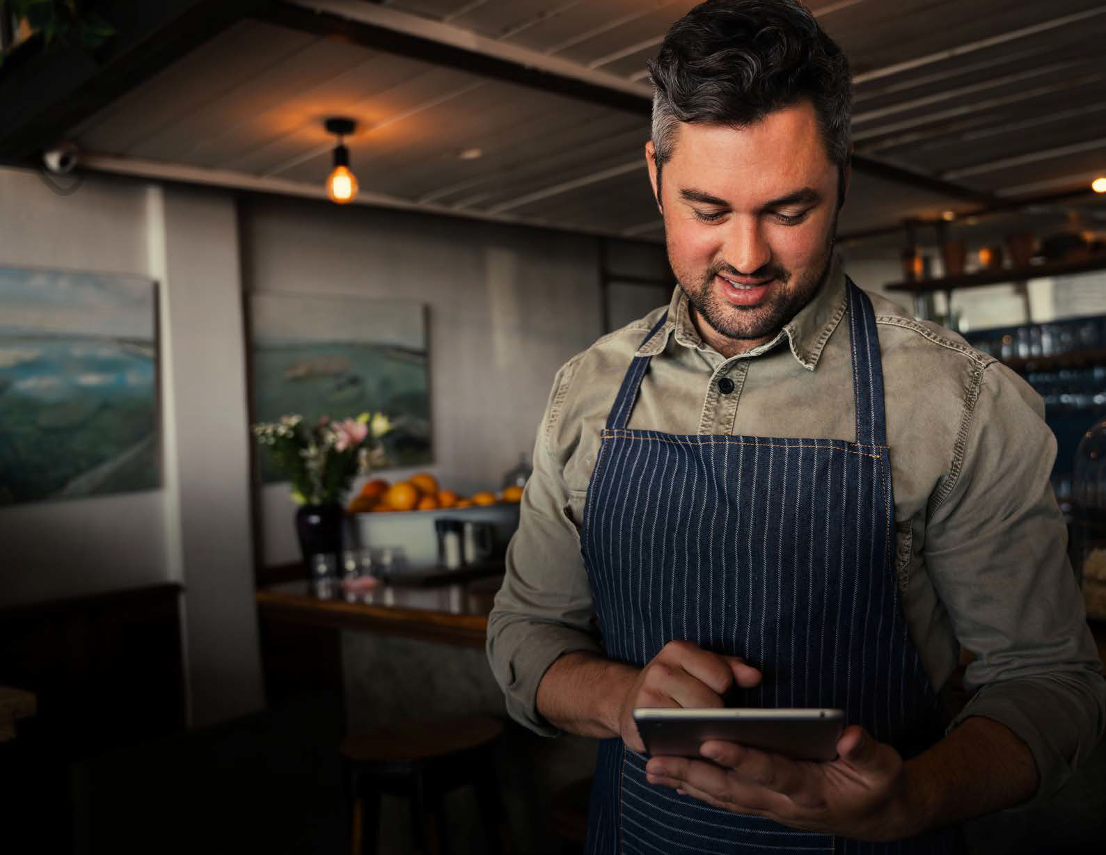 Caucasian,Male,Coffee,Shop,Owner,Smiling,At,Digital,Tablet,While